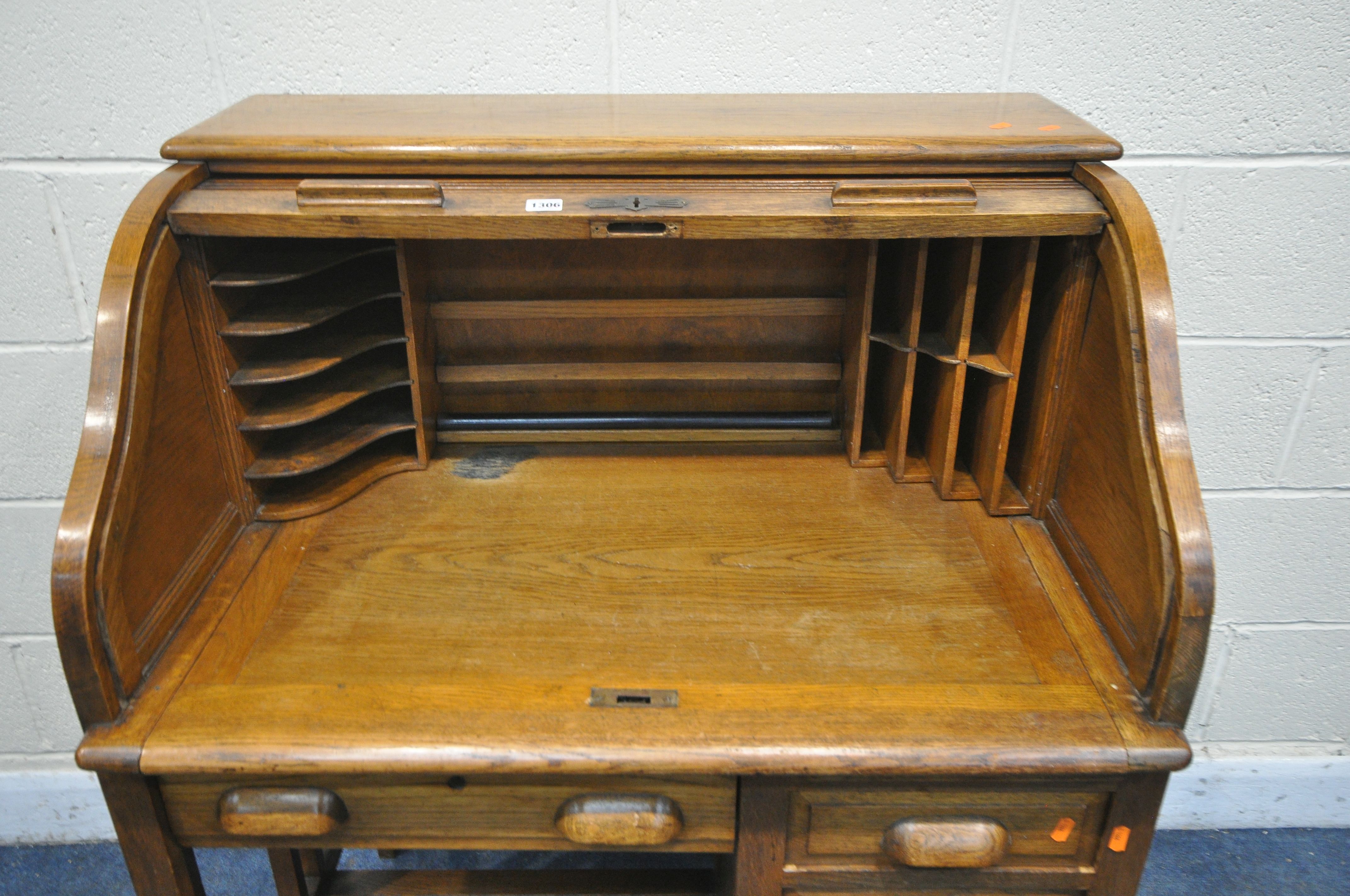 AN EARLY TO MID 20TH CENTURY OAK ROLL TOP DESK, enclosing an arrangement of pigeon holes, over - Image 3 of 4