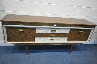 A MID TO LATE 20TH CENTURY WALNUT EFFECT FORMICA SIDEBOARD, with three drawers, flanked by a