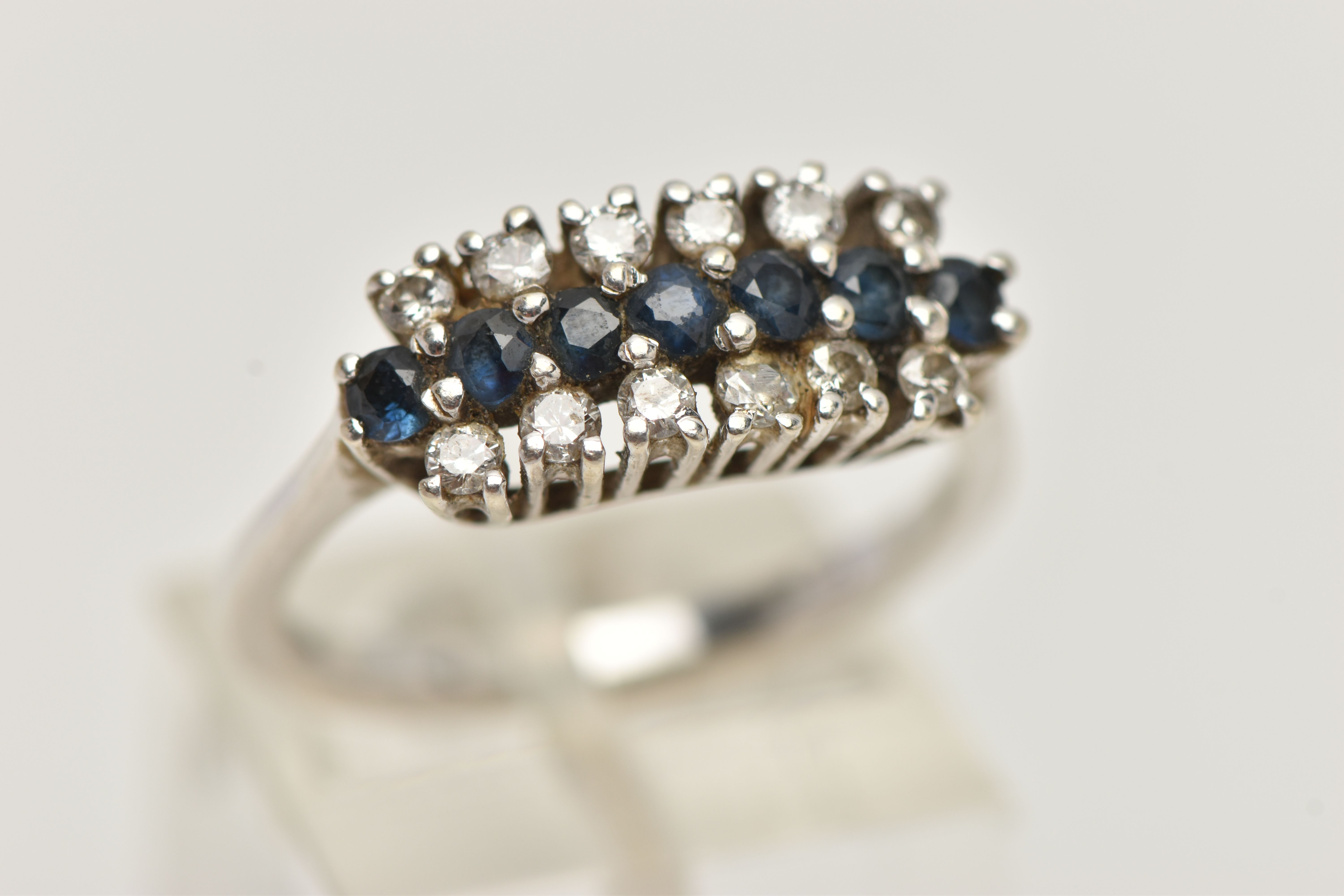 AN 18CT WHITE GOLD DIAMOND AND SAPPHIRE RING, designed with a central row of circular cut blue - Image 4 of 4