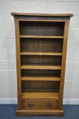 A GOLDEN OAK OPEN BOOKCASE, with four adjustable shelves, with a single drawer, width 95cm x depth