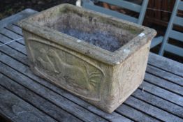 A COMPOSITE RECTANGULAR PLANTER, with otters embossed to the side, length 49cm