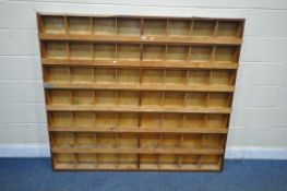 A BESPOKE WOODEN WORKSHOP PIGEON HOLE CABINET, with fifty six sections, width 167cm x depth 14cm x