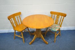 A MODERN BEECH EFFECT DROP LEAF KITCHEN TABLE, diameter 92cm x height 75cm, along with a pair of