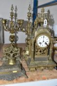 A GROUP OF BRASS WARE, comprising an gilt Rococo style mantel clock, bell striking mechanism stamped