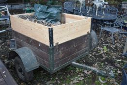 A SINGLE AXLE TRAILER, with raised sides, box full containing chopped wood, box width 93cm x 125cm x