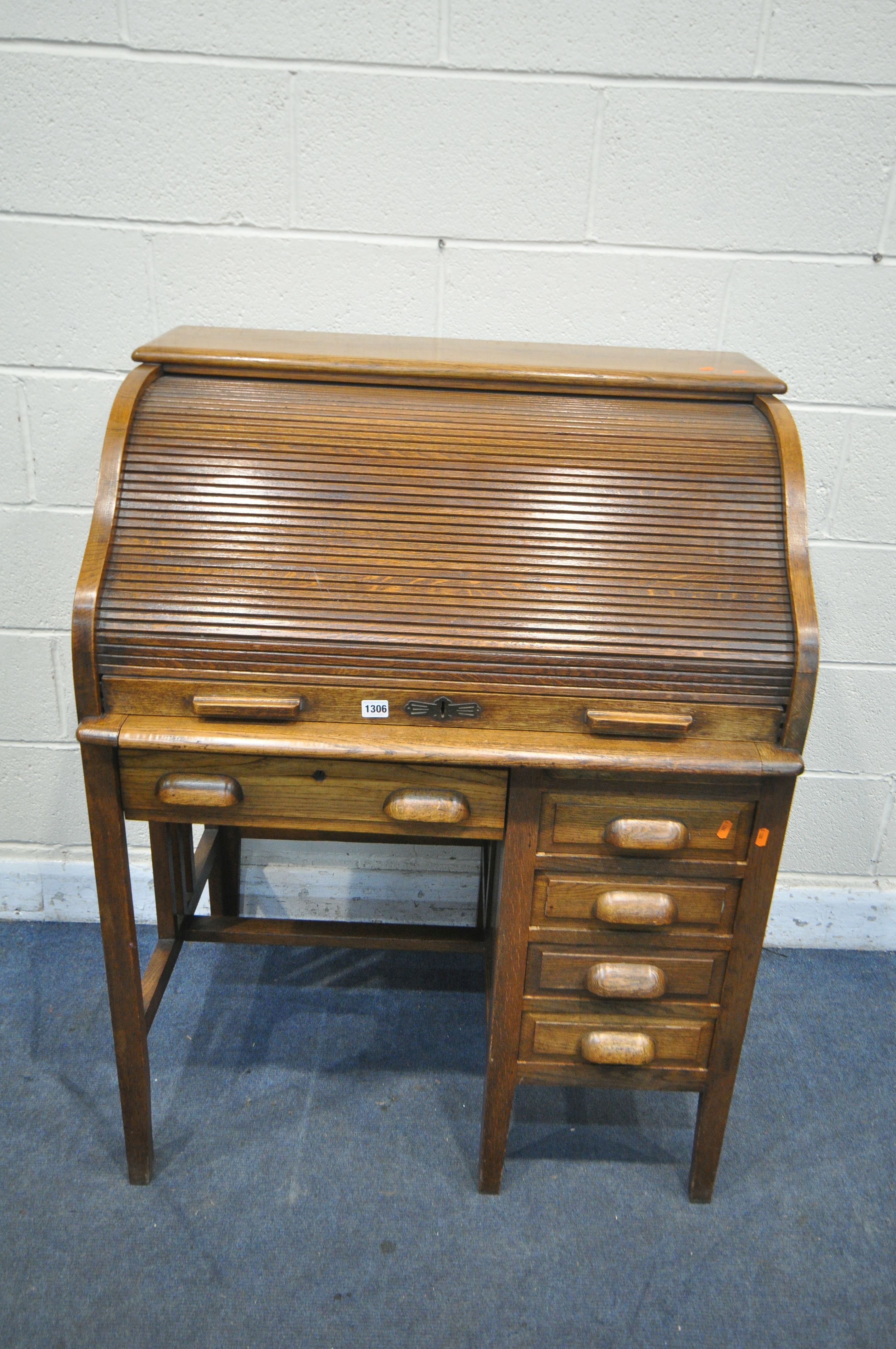 AN EARLY TO MID 20TH CENTURY OAK ROLL TOP DESK, enclosing an arrangement of pigeon holes, over - Image 2 of 4