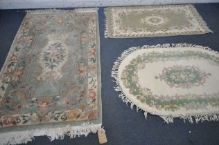 A GREEN GROUND CHINESE RUG, with floral and cream border and central medallion, 186cm x 122cm, a