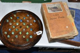 A WOODEN BAGATELLE BOARD, complete with marbles, appears in fairly good condition with only minor