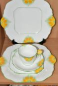 AN ART DECO AYNSLEY TRIO AND TWO CAKE PLATES, pattern number 5102, 'Butter Cup' Art Deco design with