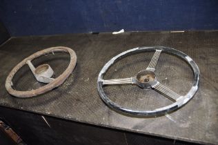 TWO VINTAGE CAR STEERING WHEELS, one 16 1/2in in diameter with five steel spokes mounted at three