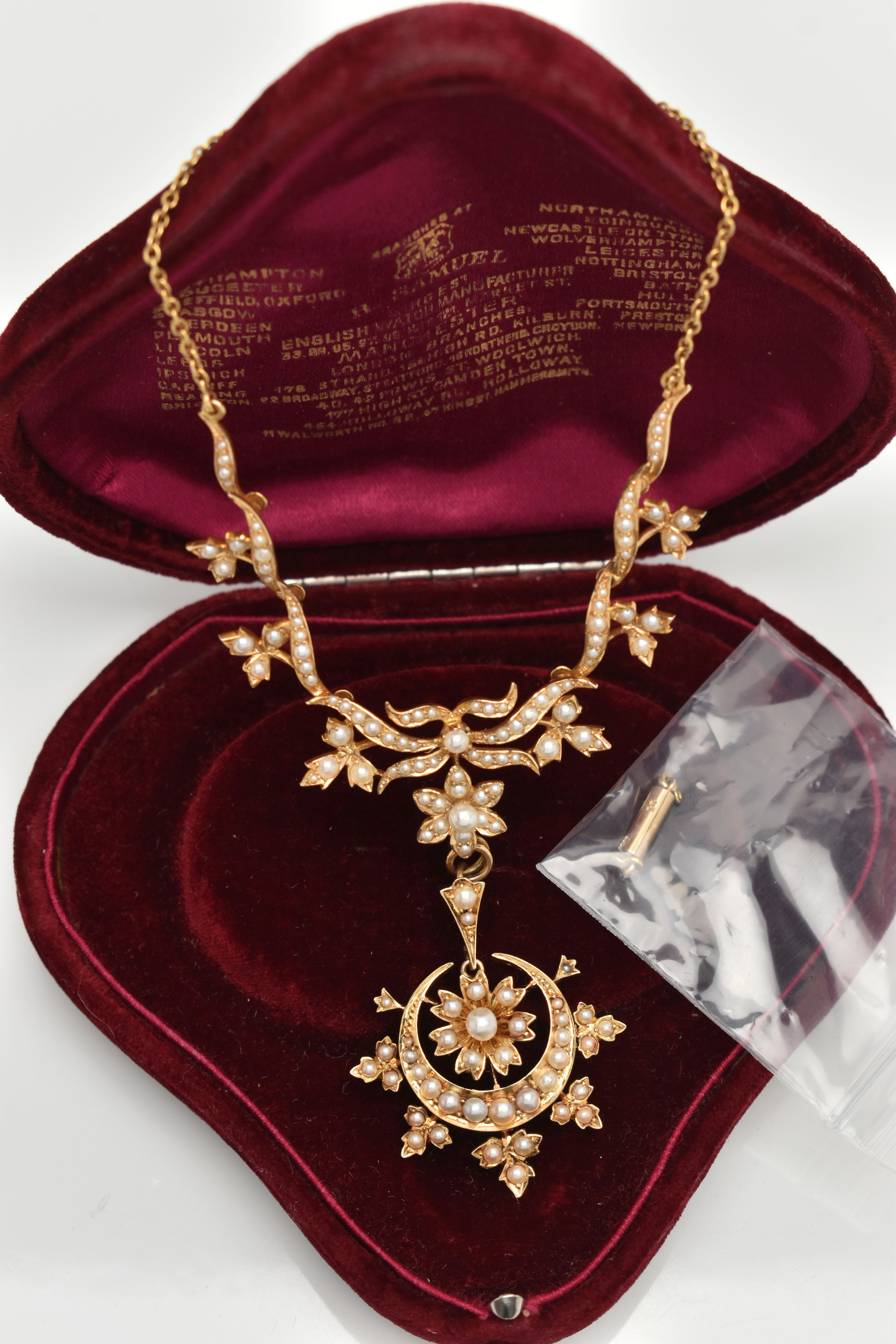 AN EARLY 20TH CENTURY GOLD AND SEED PEARL NECKLACE, a central floral piece leading on to branches