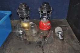 TWO PARAFFIN LAMPS, one with glass and one without and five spare flues and glasses