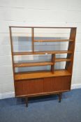 A MID-CENTURY TEAK ROOM DIVIDER, with an arrangement of shelves, above two sliding doors, on tapered
