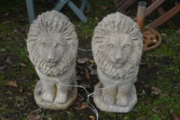 A PAIR OF WEATHERED COMPOSITE GARDEN LIONS, height 50cm (condition report: good) (2)