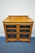 A 20TH CENTURY SATINWOOD AND MARQUETRY INLAID BOOKCASE, with a raised back, two glazed doors, on