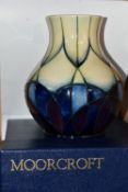 A BOXED MOORCROFT POTTERY VASE, 'Indigo' pattern, designed by Emma Bossons, c.1999, decorated with