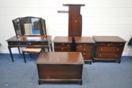 A STAG MINSTREL SEVEN PIECE BEDROOM SUITE, comprising a dressing table, with triple swing mirror and