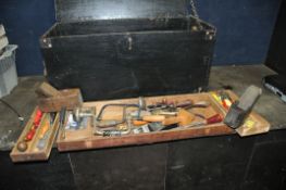 A WOODEN CARPENTERS TOOLBOX CONTAINING TOOLS including saws, shoulder and hand braces, two wooden