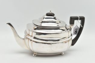 A GEORGE III SILVER TEAPOT, polished form, worn engraved crests to either side, on four ball feet,