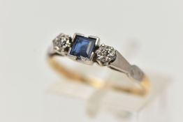 A YELLOW METAL SAPPHIRE AND DIAMOND RING, set with a central square cut blue sapphire, flanked