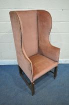 AN EARLY 20TH CENTURY GEORGIAN STYLE HIGH WING BACK ARMCHAIR, with pink studded upholstery, width