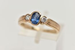 A 9CT GOLD SAPPIRE AND DIAMOND RING, designed with a central oval cut blue sapphire, collet set,
