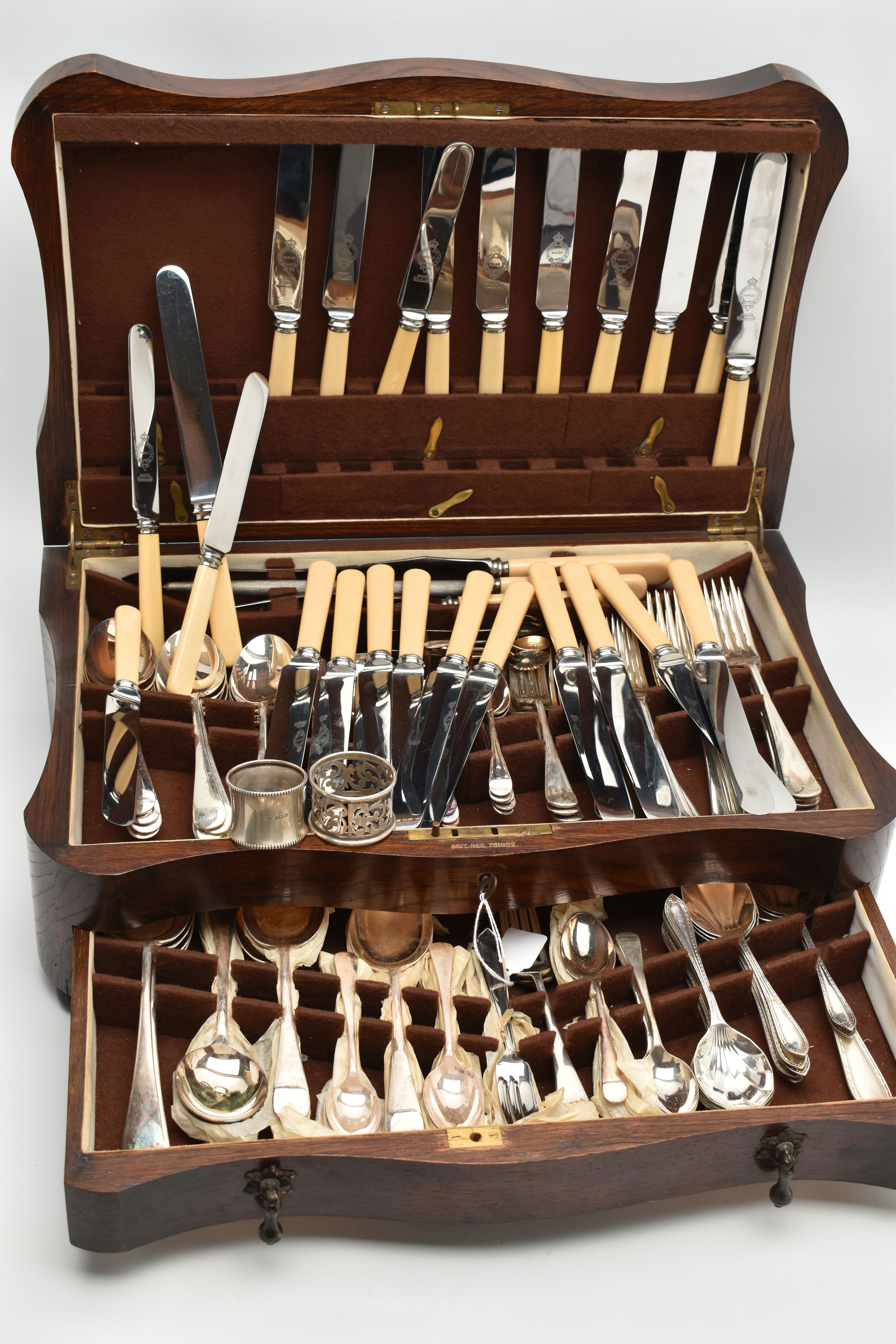 A WOODEN CANTEEN, stainless steel cutlery for a twelve person table setting, knives fitted with