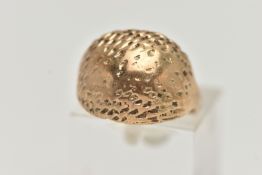 A YELLOW METAL DOME RING, textured dome, to a polished band, unmarked, ring has been resized, ring