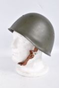 A RUSSIAN COLD WAR ERA STEEL HELMET, it is green in colour and features a red star on the front, the