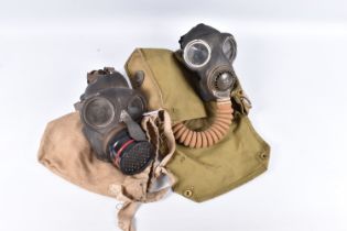 TWO MILITARY GAS MASKS IN CANVAS BAGS, the first comes in a khaki coloured bag that has 31 stamped