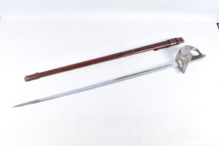 A NINETEENTH OR TWENTIETH CENTURY BASKET HILT SWORD WITH DECORATED BLADE, this sword comes in its