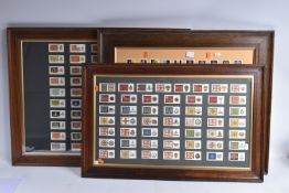 THREE FRAMED AND GLAZED DISPLAYS OF MILITARY CAP BADGES AND KINGS COLOURES, the cards include one