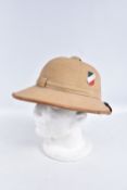A WWII ERA GERMAN AFRIKACORPS PITH HELMET WITH DECALS, this is the beige coloured tropical sun hat