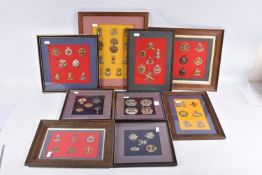 NINE FRAMED AND GLAZED DISPLAYS OF MILITARY CAP BADGES, these are mainly Scottish, Welsh,