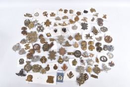 A LARGE ASSORTMENT OF MILITARY CAP BADGES, COLLAR BADGES AND SHOULDER TITLES, these include a NCC (