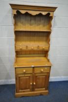 A MODERN PINE DRESSER, the top with two shelves and three drawers, the base with two drawers,