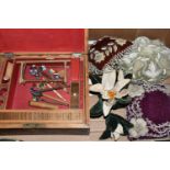 ONE BOX OF VICTORIAN BEADED PIN CUSHIONS AND SEWING SUNDRIES, to include a wooden sewing box