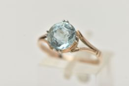AN AQUAMARINE RING, designed as a circular cut aquamarine in a double four claw setting to the