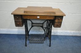 AN OAK CASED SINGER TREADLE SEWING MACHINE, with four drawers, serial number Y5344195, open width