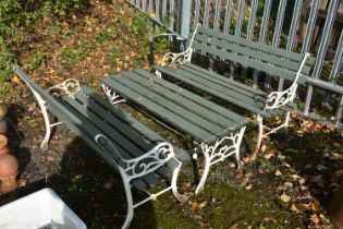 A WROUGHT IRON THREE PIECE GARDEN SET, comprising two benches, and a table (condition report: rusted