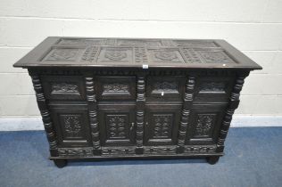 A 20TH CENTURY CARVED OAK CABINET, with an arrangement of foliate panels, including the top surface,