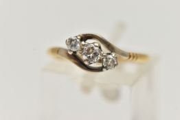 A THREE STONE CROSSOVER DIAMOND RING, designed as a diagonal line of three brilliant cut diamonds in