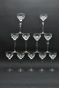 ELEVEN 20TH CENTURY HOCK STYLE WINE GLASSES, the bowls decorated with a cut cross and olive repeat