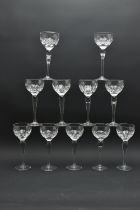 ELEVEN 20TH CENTURY HOCK STYLE WINE GLASSES, the bowls decorated with a cut cross and olive repeat