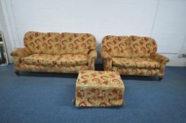 A GOLDEN GAINSBOROUGH GOLD THREE PIECE LOUNGE SUITE, with floral red patterns, comprising a three