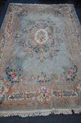 A VERY LARGE CHINESE WOOLLEN RUG, 540cm x 359cm (condition report: stains in various places, sides