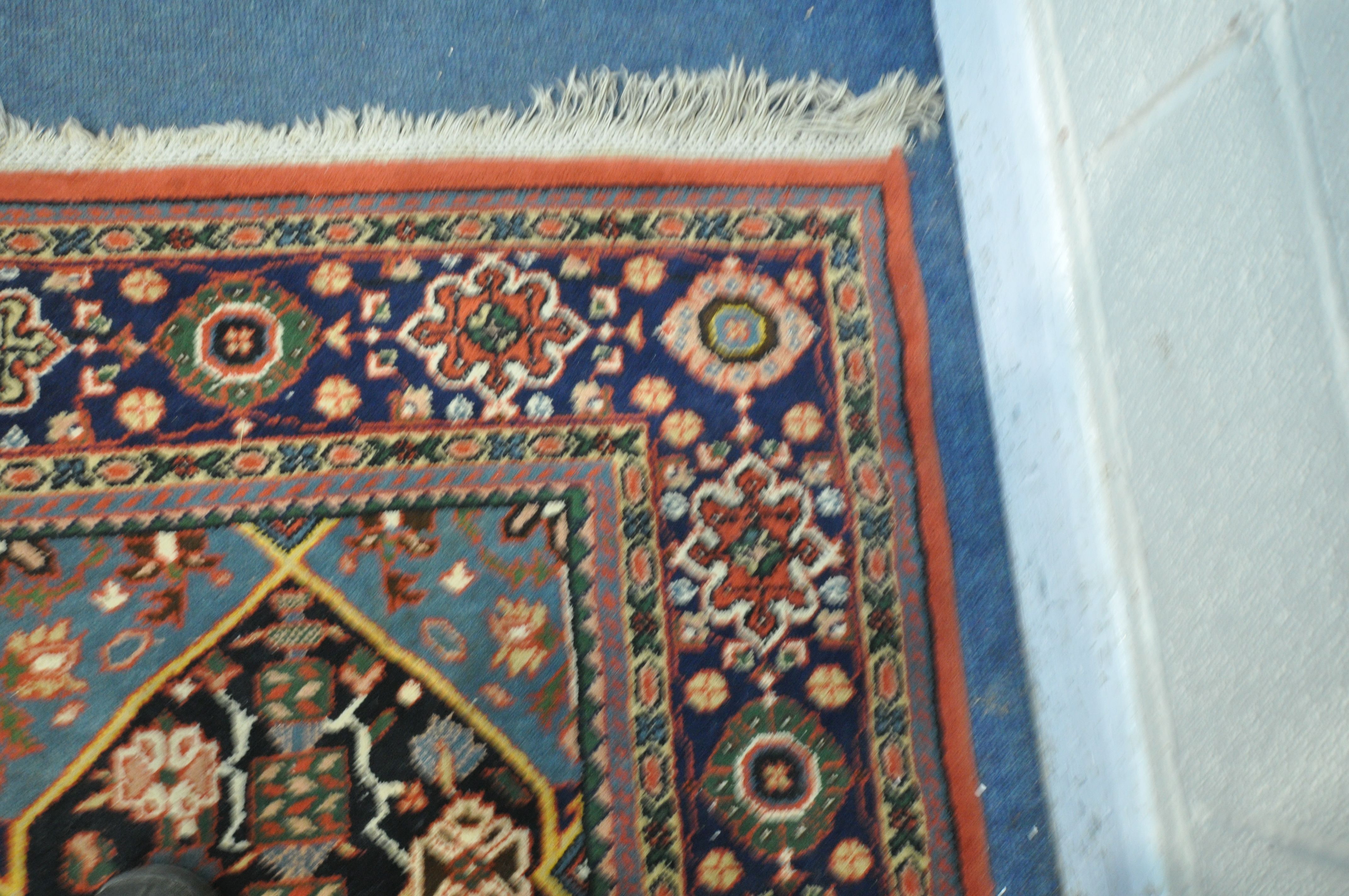 A WOOLMARK RED GROUND RUG, with geometric and floral design, 287cm x 283cm (condition report: - Image 3 of 4