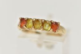 A 9CT GOLD GEM SET RING, designed as a line of oval cut gems, the central three assessed as possibly