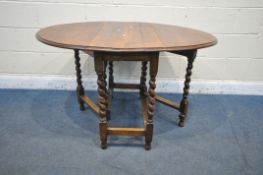 A 20TH CENTURY OAK OVAL GATE LEG TABLE, with barley twist supports, open length 121cm x closed