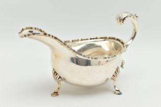 AN ELIZABETH II SILVER SAUCE BOAT, a scalloped edge sauce boat with three hooved feet, hallmarked 'T